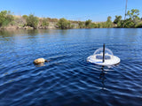 Solar-powered lake water monitoring device floating on water near shoreline, Lake Pulse